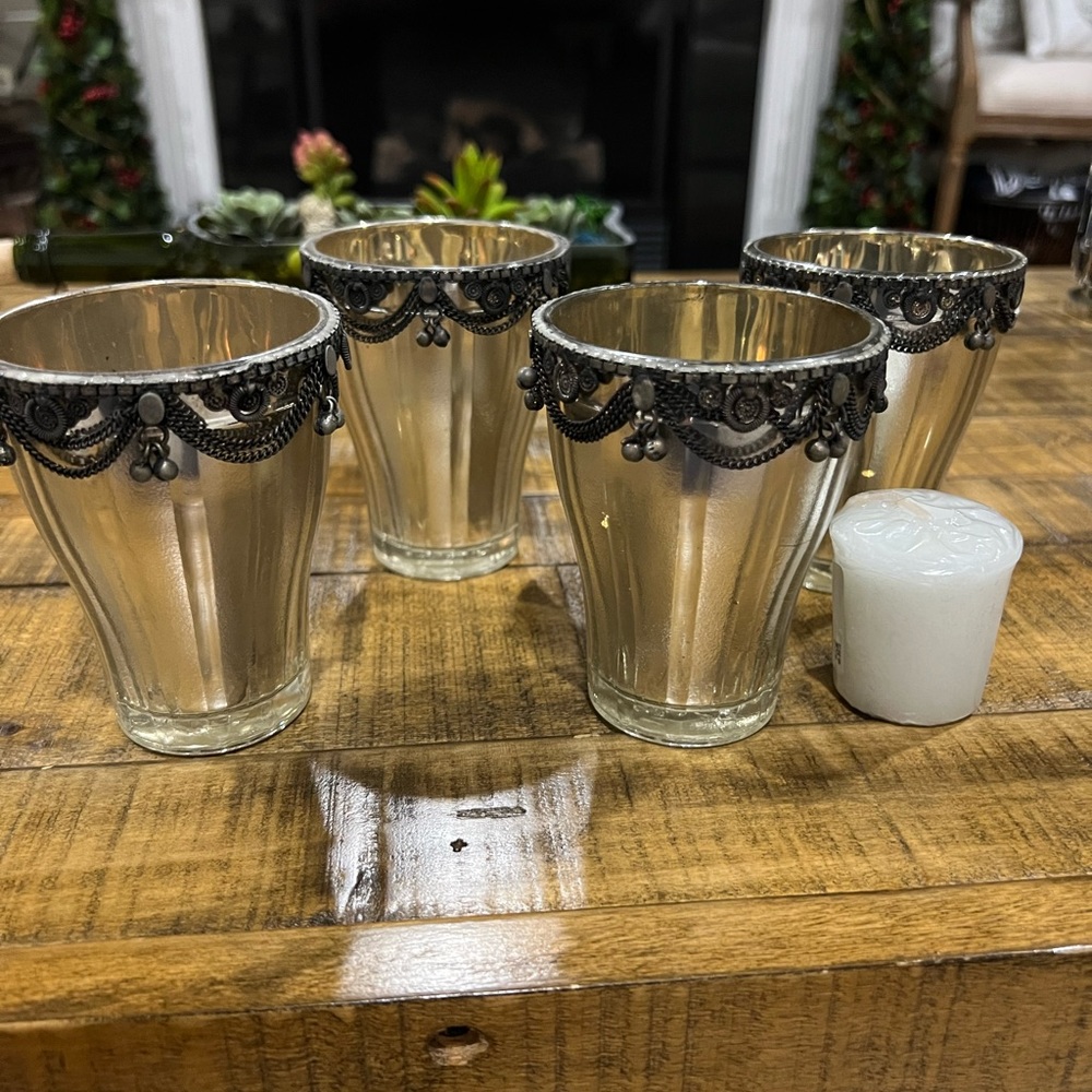 New. Set of 4 candle holders. Silver with black accents.